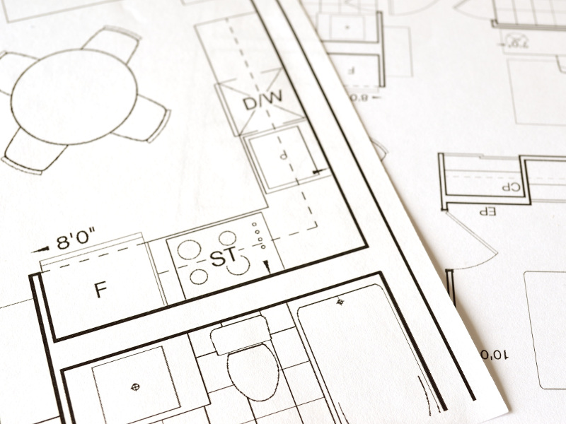 Construction process with blueprints and tools