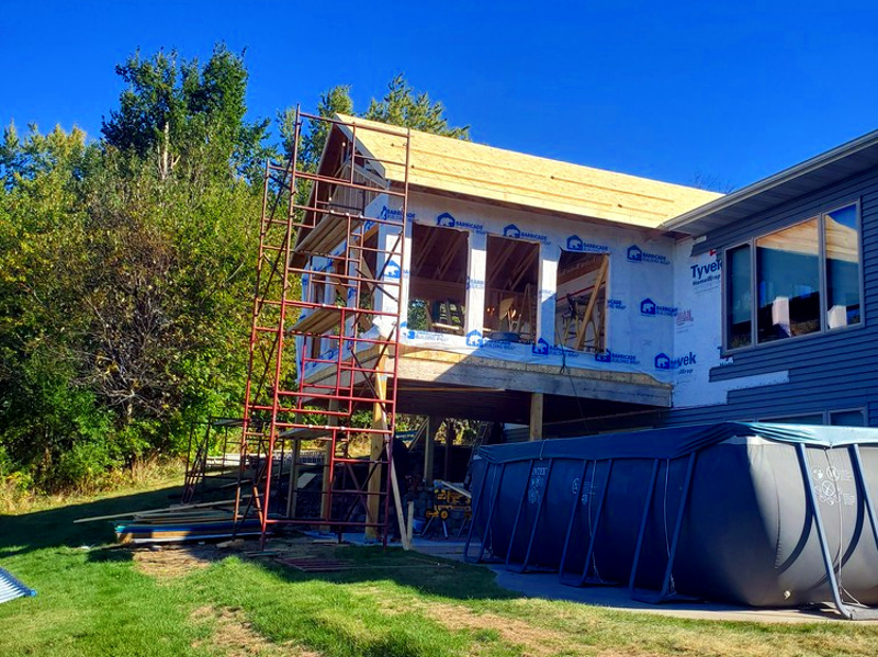 Home addition contractor reviewing blueprints and construction plans for a Western Wisconsin home addition project