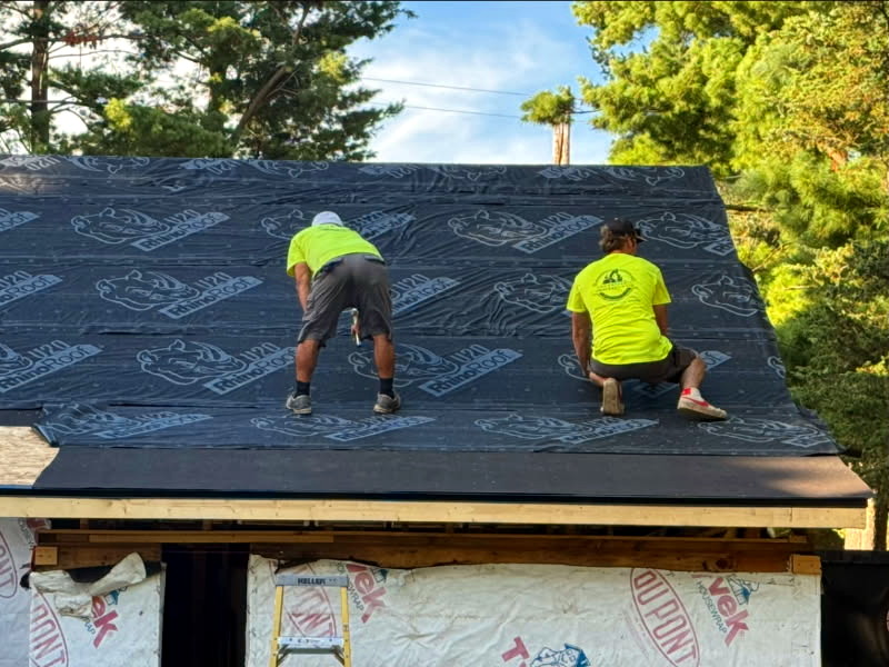 Roofing process with professionals at work